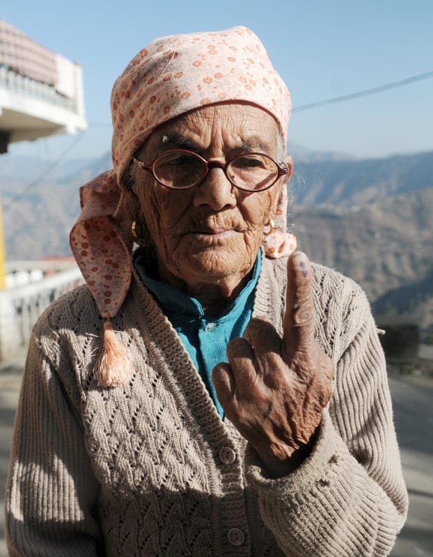 An elderly voter showing her marked finger after casting her vote at a…