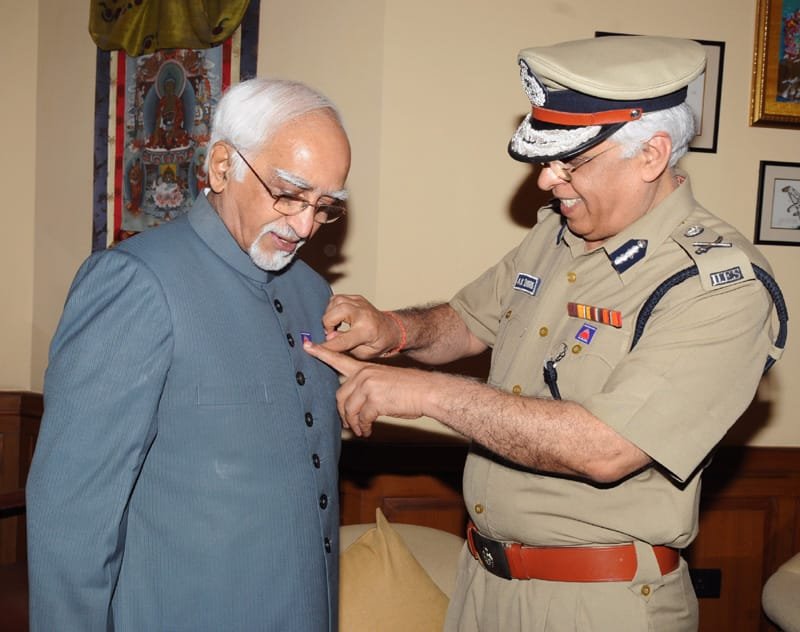 The Director-Delhi Fire Services, Shri A.K. Sharma pinning a Flag to…