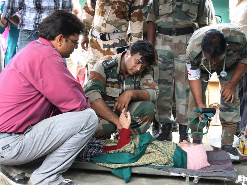 The Army doctors provide medical help to a seriously ill pilgrim, in Gauchar, Uttarakhand.