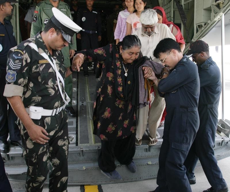 IAF personnel help rescued pilgrims to alight from a C-130J Air Craft, during their relief & res..