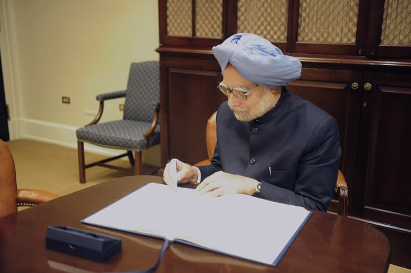 The Prime Minister, Dr. Manmohan Singh signing the visitors book, during the...