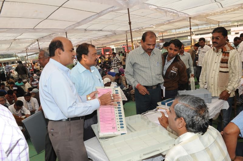 Polling officials receiving the Electronic Voting Machines (EVM`s) and inspect the same in…