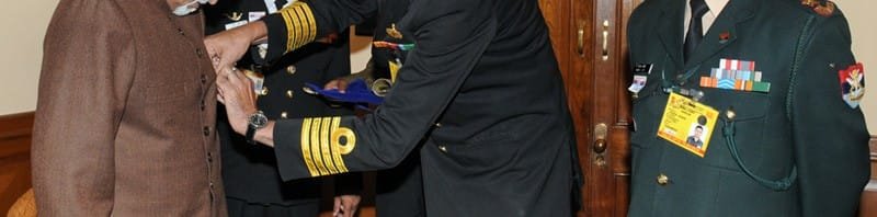 A service officer from Kendriya Sainik Board pinning a lapel on the Vice President,...