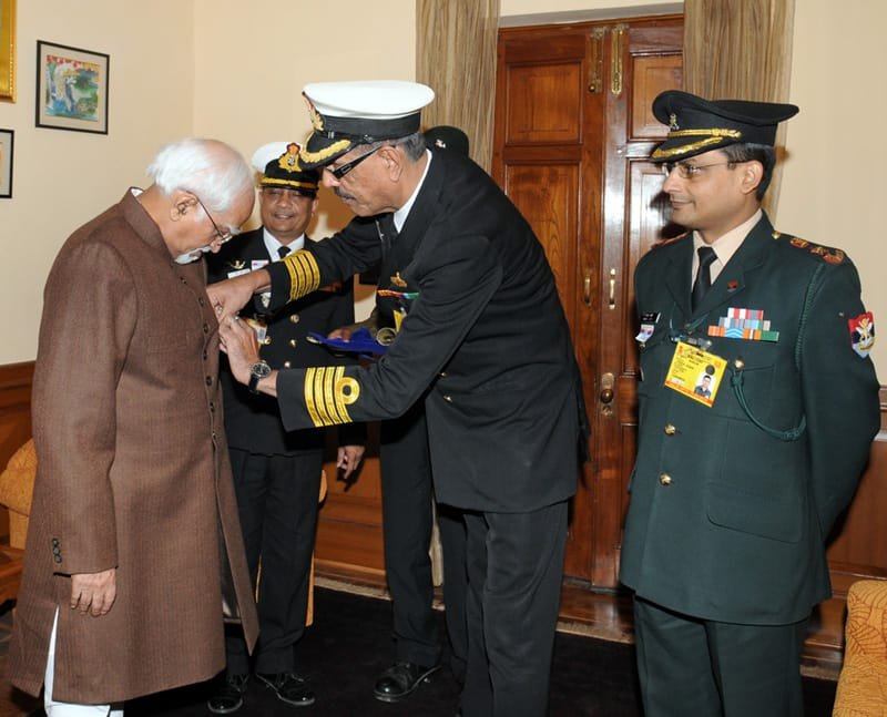 A service officer from Kendriya Sainik Board pinning a lapel on the Vice President,…