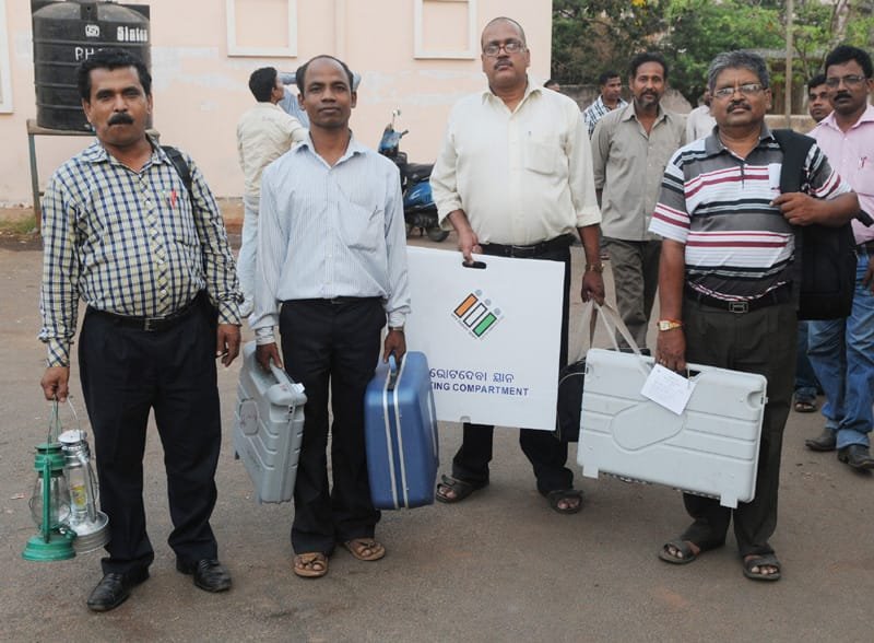 Polling officials carrying the Electronic Voting Machines (EVM’s) and other…