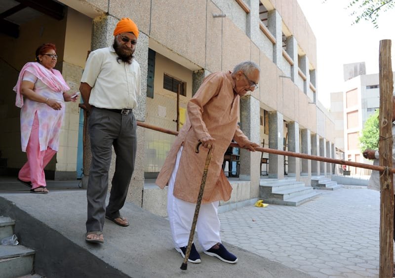 An old man coming out from the booth after casting his vote, at a polling booth…