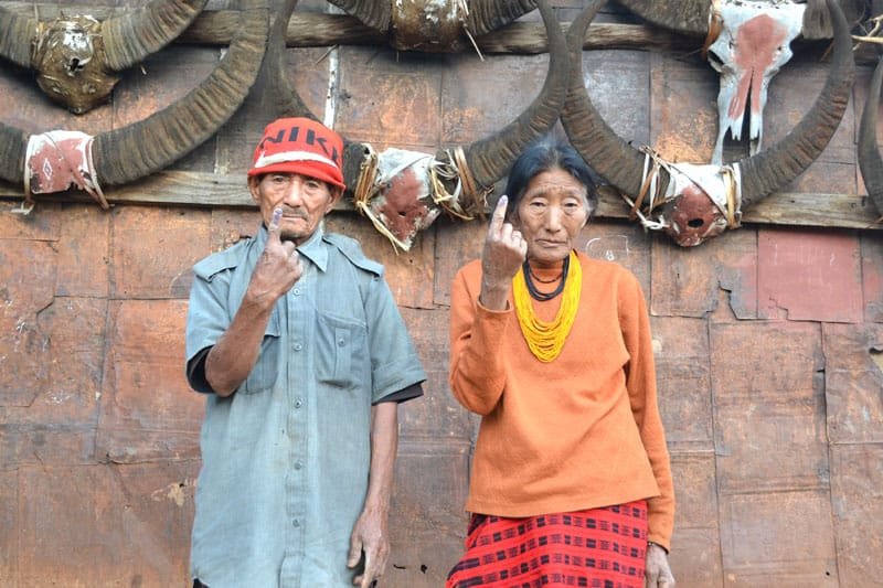 An old couple showing mark of indelible ink after casting their votes, at a polling…