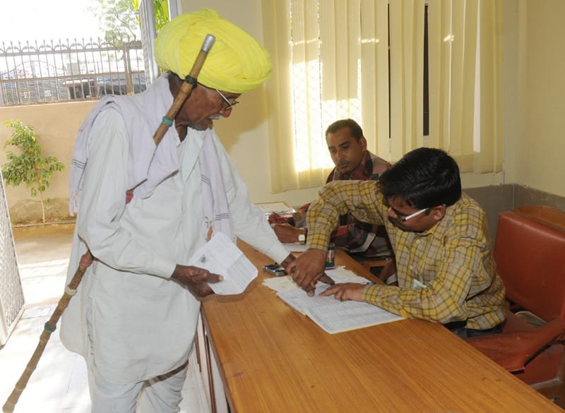 An elderly voter being registered his name to cast his vote, at a polling…