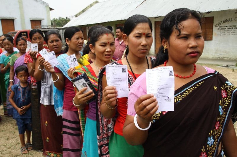 Tribal voters standing in a queue at a polling booth to cast their votes…