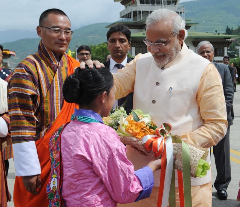 The Prime Minister, Shri Narendra Modi blessing a Bhutanese girl child,...