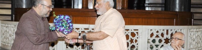 The Prime Minister, Shri Narendra Modi presenting a bouquet to the...