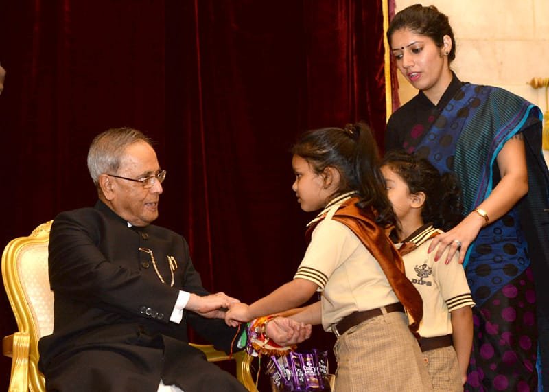 Children tying ‘Rakhi’ to the President, Shri Pranab Mukherjee, on the occasion…