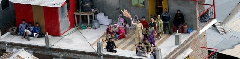 Stranded people signaling for help in the flood affected part of Srinagar