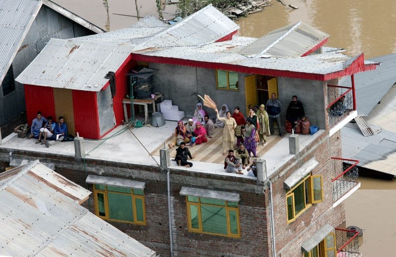 Stranded people signaling for help in the flood affected part of Srinagar