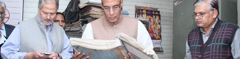 The Union Home Minister, Shri Rajnath Singh checking the records, during his ...