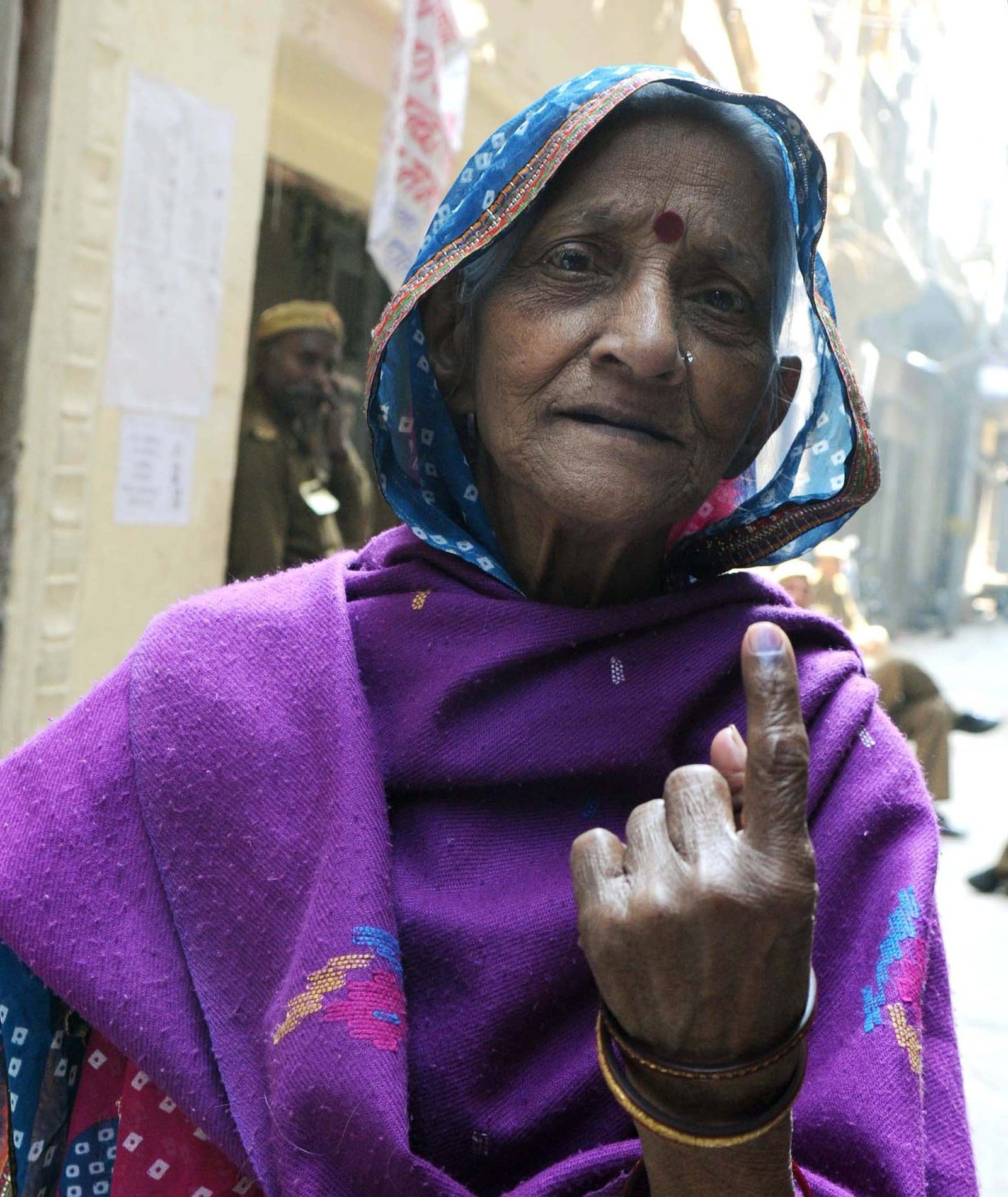 An Elderly woman voter showing mark of indelible ink after casting ..