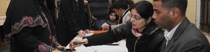 A female voter being administered indelible ink, at a polling booth, during the Delhi Assembly Election, in Delhi