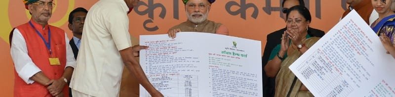 The Prime Minister, Shri Narendra Modi giving 'Soil Health Card' to a farmer at ...