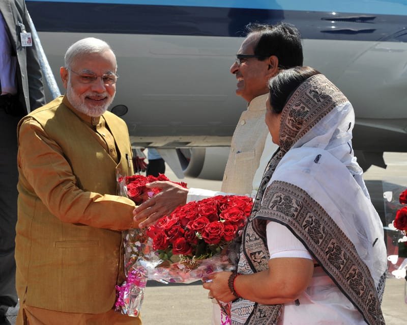 The Prime Minister, Shri Narendra Modi being received by the Chief Minister of Madhya Pradesh,..