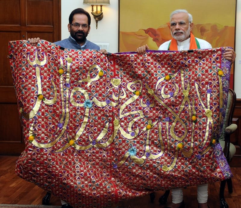 The Prime Minister, Shri Narendra Modi handing over the “Chaadar” to be offered at Dargah of Khwaja Moinuddin Chishti, Ajmer Sharif, to the Minister of State for Minority Affairs and Parliamentary Affairs, Shri Mukhtar Abbas Naqvi, in New Delhi