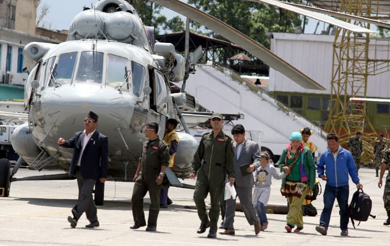 Rescued persons including children are being de-boarded to a safer place by..