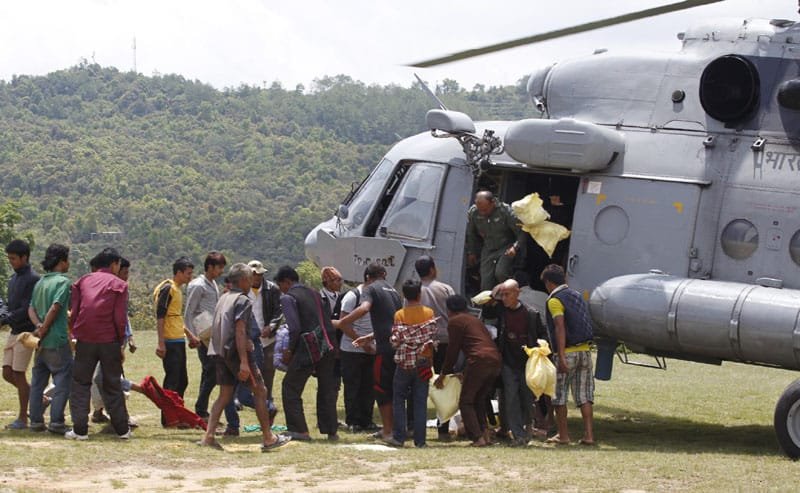 Stranded persons to be taken to a safer place, queuing up for boarding an Indian Air ..