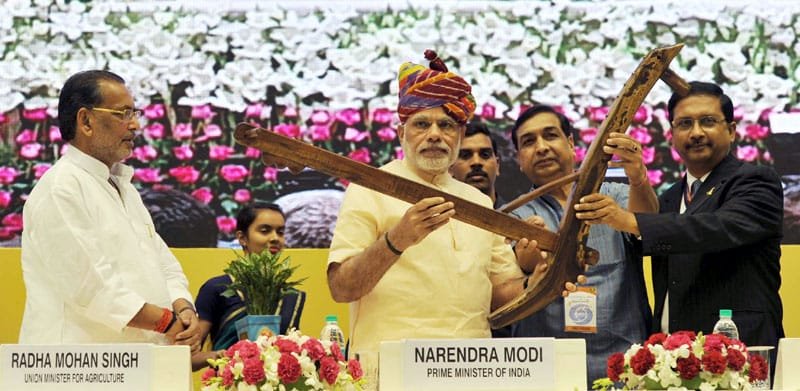 The Prime Minister, Shri Narendra Modi being presented a “Plough” as symbol of..
