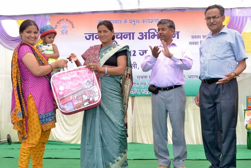 The Jakholi Block Pramukh, Smt Rajkumari Rawat giving away prize of healthy baby show, at ..
