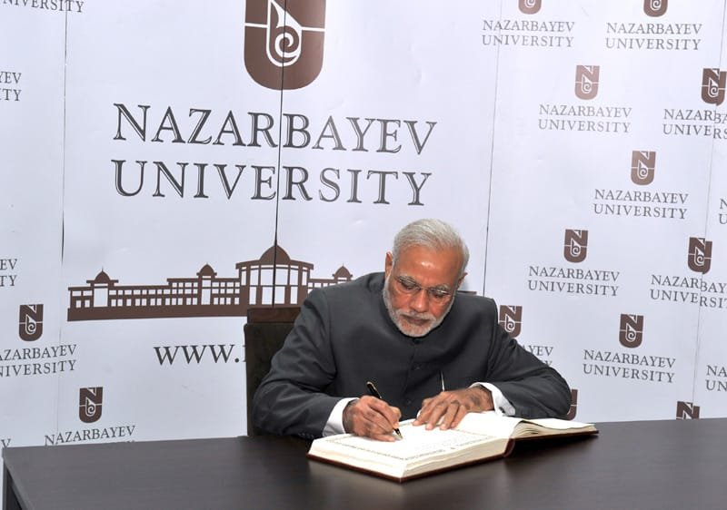 The Prime Minister, Shri Narendra Modi signing the visitors’ book at the…