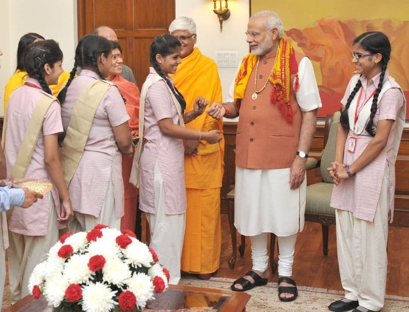 A group of girl students from the Vatsalya Gram Vrindavan tying Rakhi on the..