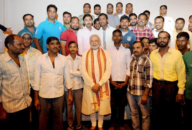 The Prime Minister, Shri Narendra Modi in a group photo with the Indian workers at the..