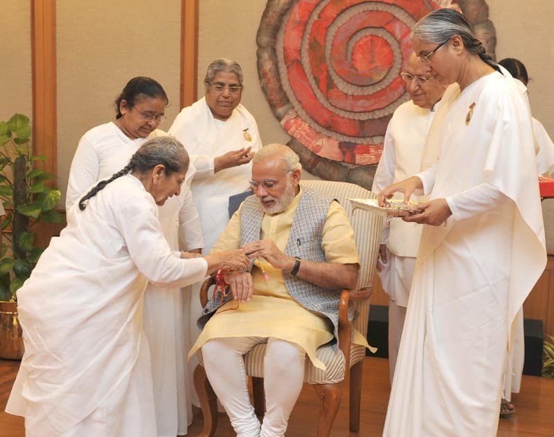 Women from various segments of society tying ‘Rakhi’ on the Prime Minister, Shri Narendra Modi’s ..