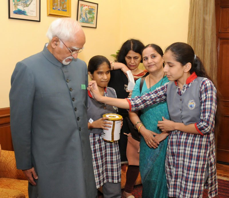 A delegation of visually impaired children of the National Association for the Blind, pinning..