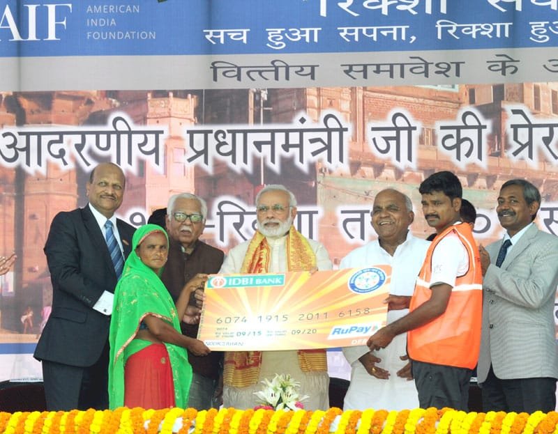 The Prime Minister, Shri Narendra Modi distributing the RuPay Cards to the ..