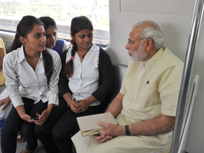 The Prime Minister, Shri Narendra Modi interacting with the co-passengers while travelling by the Delhi Metro to Faridabad