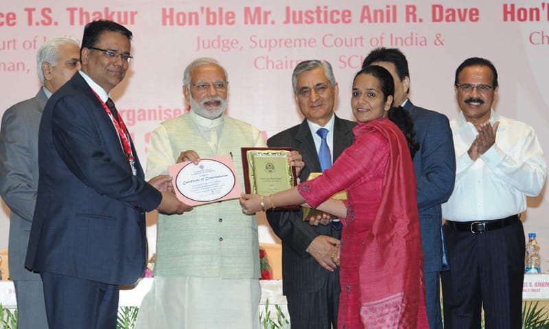 The Prime Minister, Shri Narendra Modi felicitating the best district legal service ..