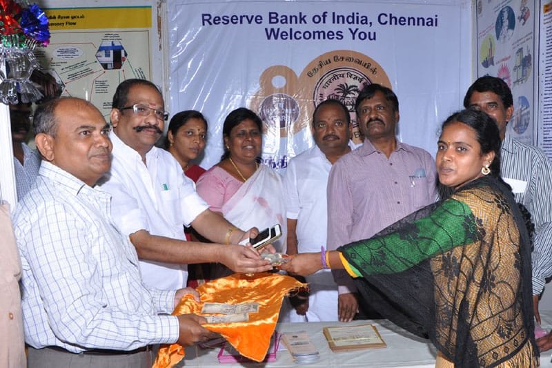 The Member of Parliament, Shri S. Muthukaruppan handing over coins in lieu of ..