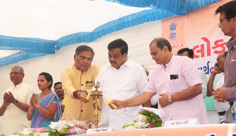 The Member of Parliament, Navsari, Shri C.R. Paatil lighting the lamp at the Public Information Campaign,..