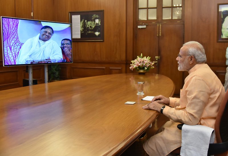 The Prime Minister, Shri Narendra Modi interacting with Mata Amritanandamayi ..