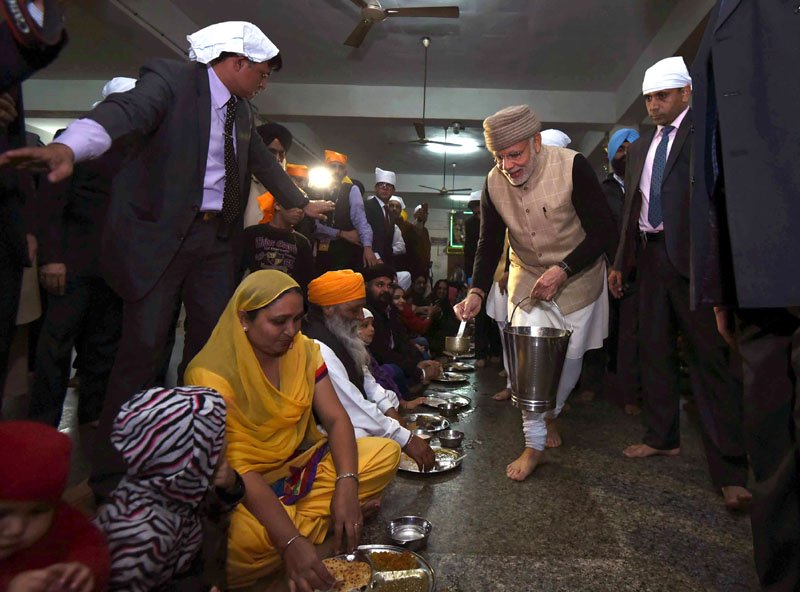 The Prime Minister, Shri Narendra Modi serving ‘Langar’ at the Golden Temple..
