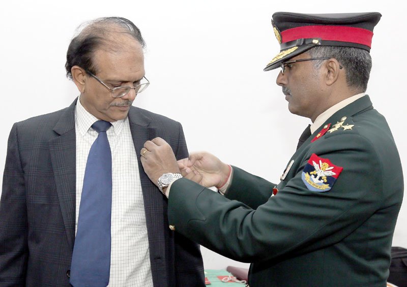 The Secretary, Kendriya Sainik Board, Brig. M.H. Rizvi pinning a lapel on ..