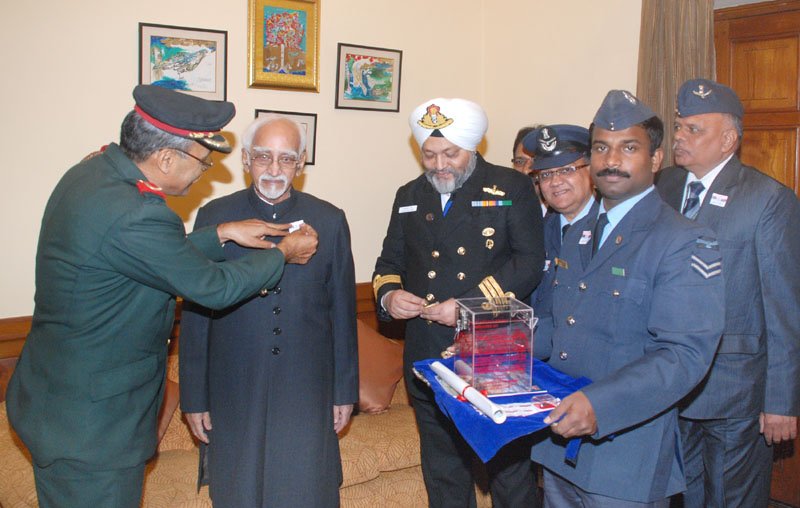 The Vice President, Shri M. Hamid Ansari being presented with the ‘Flag Sticker’, ..