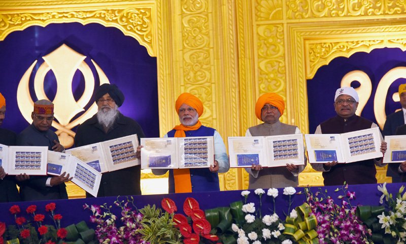The Prime Minister, Shri Narendra Modi releasing the commemorative..